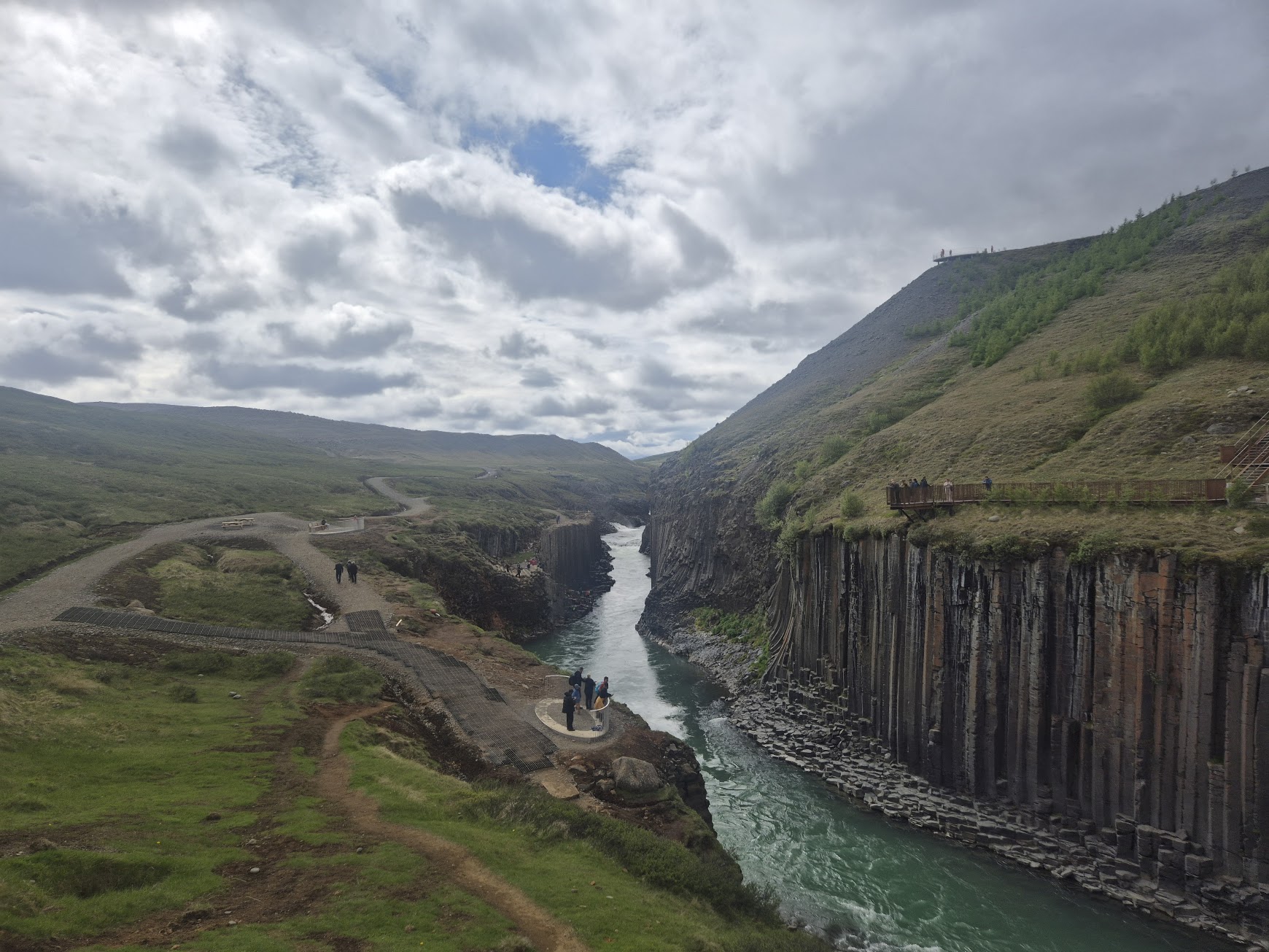 Stuðlagil canyon with towering basalt columns and turquoise river seen from the east viewing platform