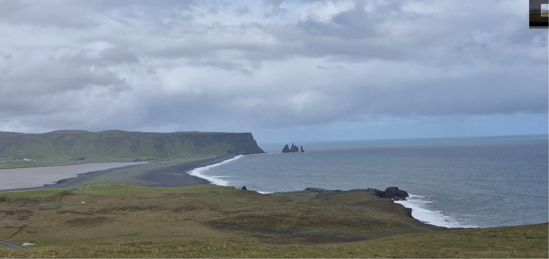 Wide view of Reynisfjara coastline and Reynisdrangar sea stacks from Dyrhólaey