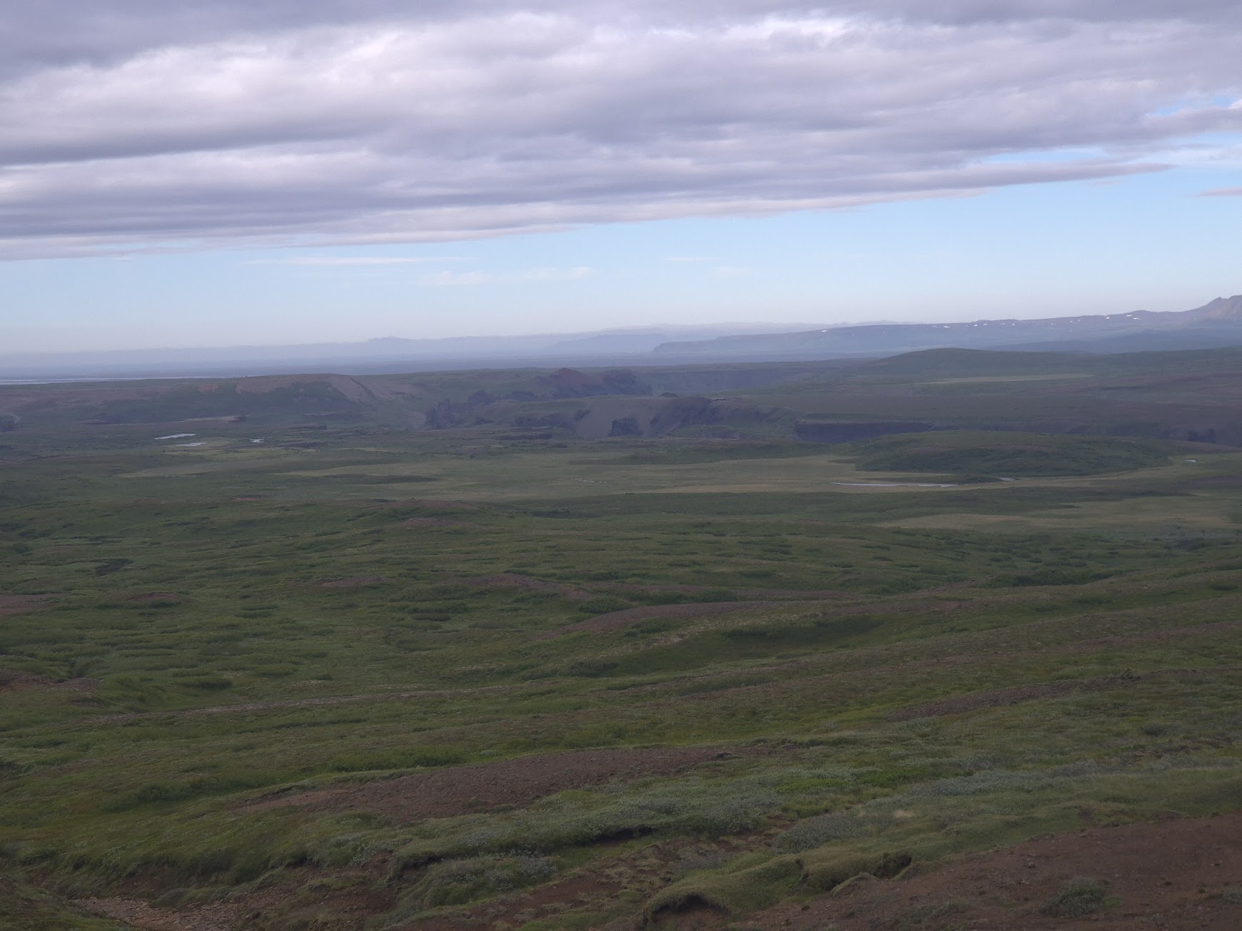 Mossy lowlands and distant cliffs in the Vatnajökull National Park area around Hljóðaklettar