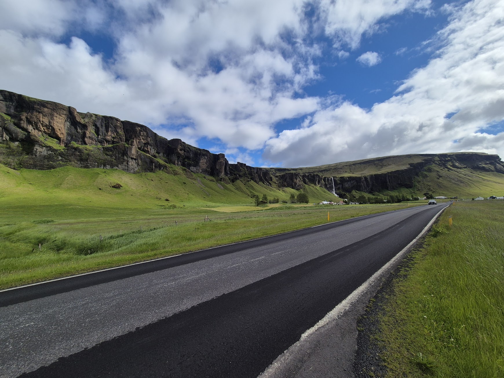 South Coast road in Iceland with green cliffs and open sky